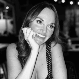 Erica Suzanne Fultz sat at a bar resting her head in her hand in black and white.