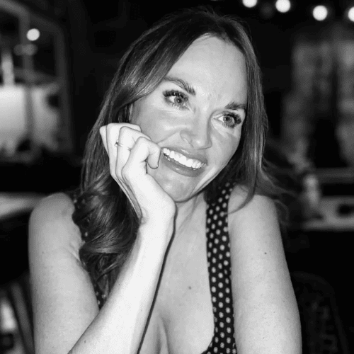 Erica Suzanne Fultz sat at a bar resting her head in her hand in black and white.