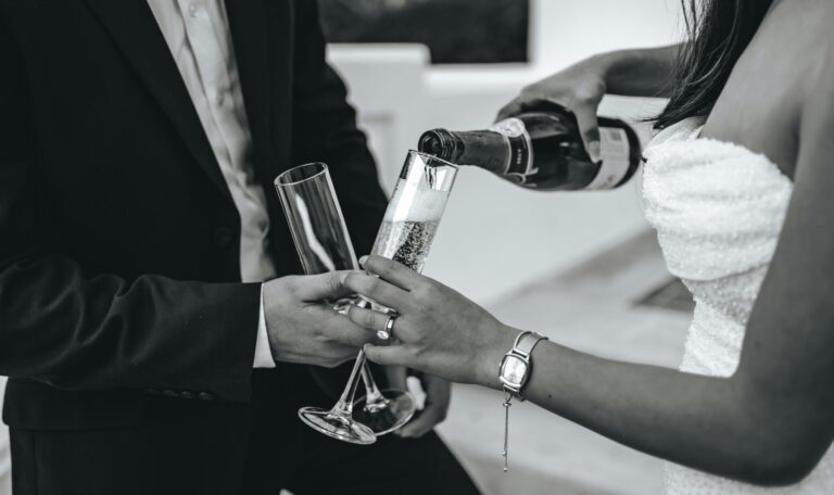 Man and wife at wedding pouring champagne